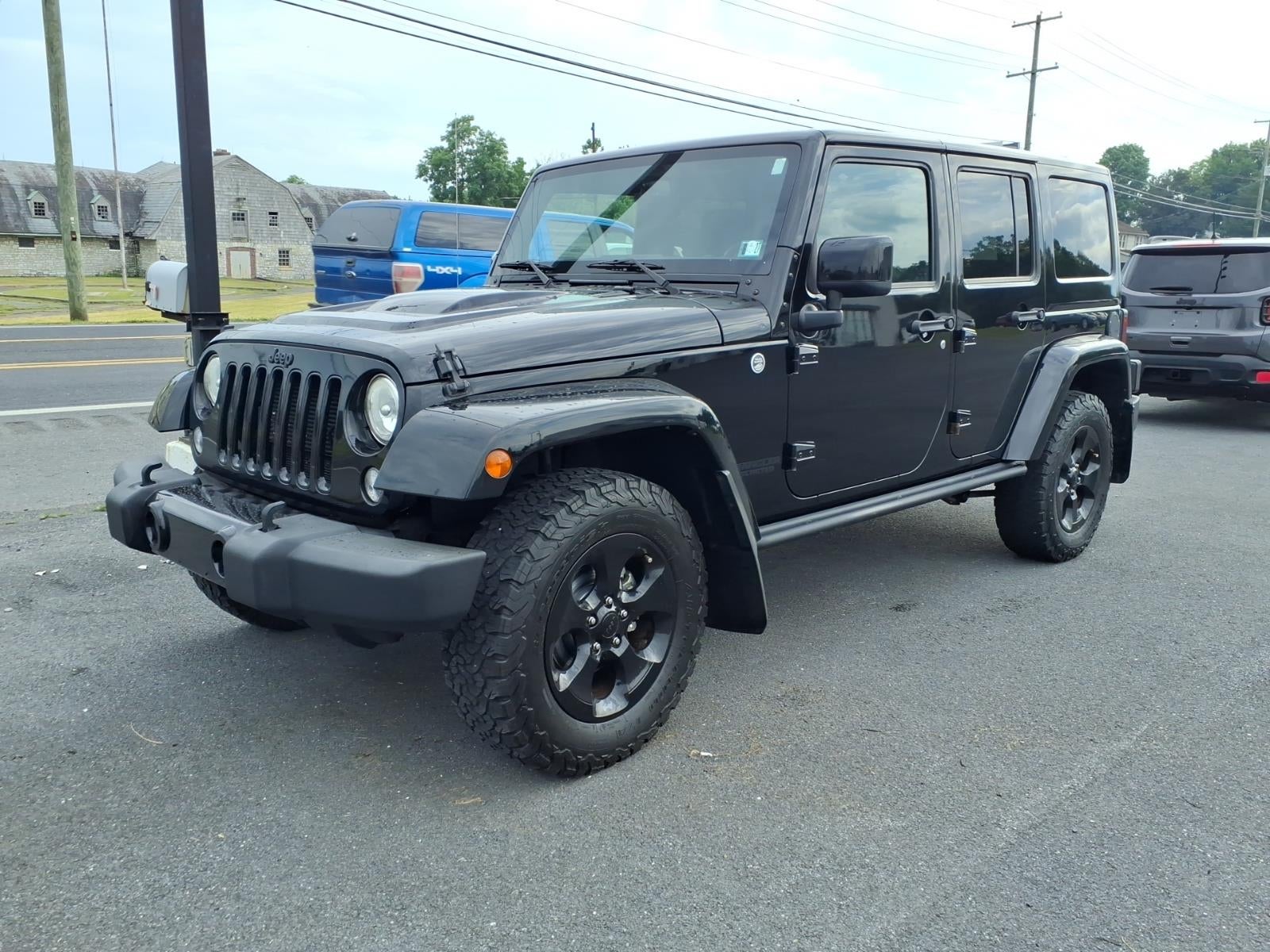 2015 Jeep Wrangler Unlimited Altitude in Black — front three-quarter view