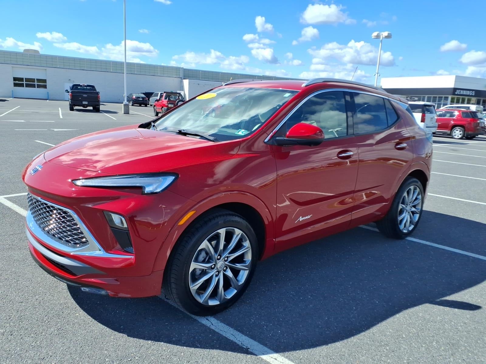 2026 Buick Encore GX Avenir in Brilliant Red — front three-quarter view
